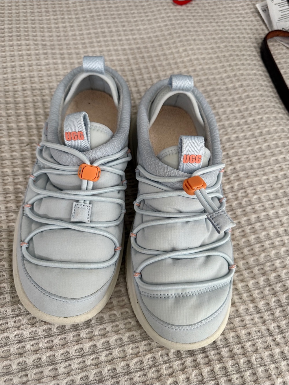 UGG Women’s Pale Blue Slip-On Sneakers with Orange Toggle in size 6
